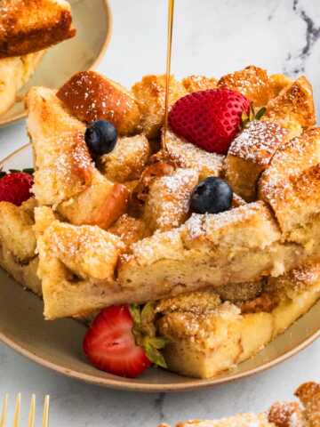 maple syrup drizzling over slices of brioche French toast casserole