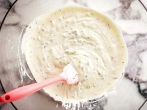 overhead view of mayonnaise dressing in clear glass bowl