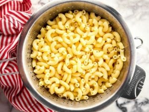 overhead view of boiled macaroni draining in colander
