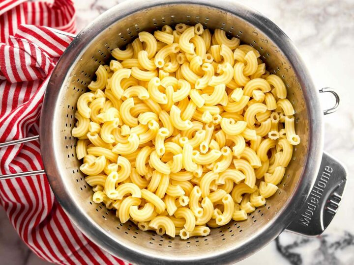 overhead view of boiled macaroni draining in colander