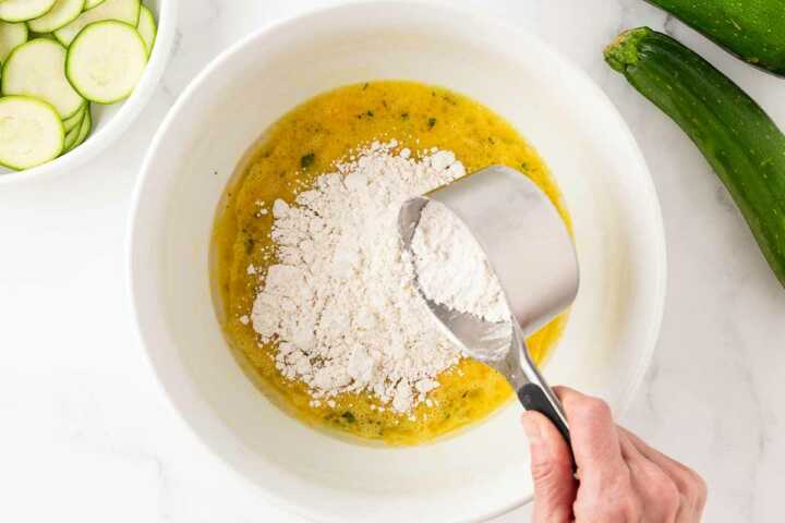 Bisquick being added to beaten eggs