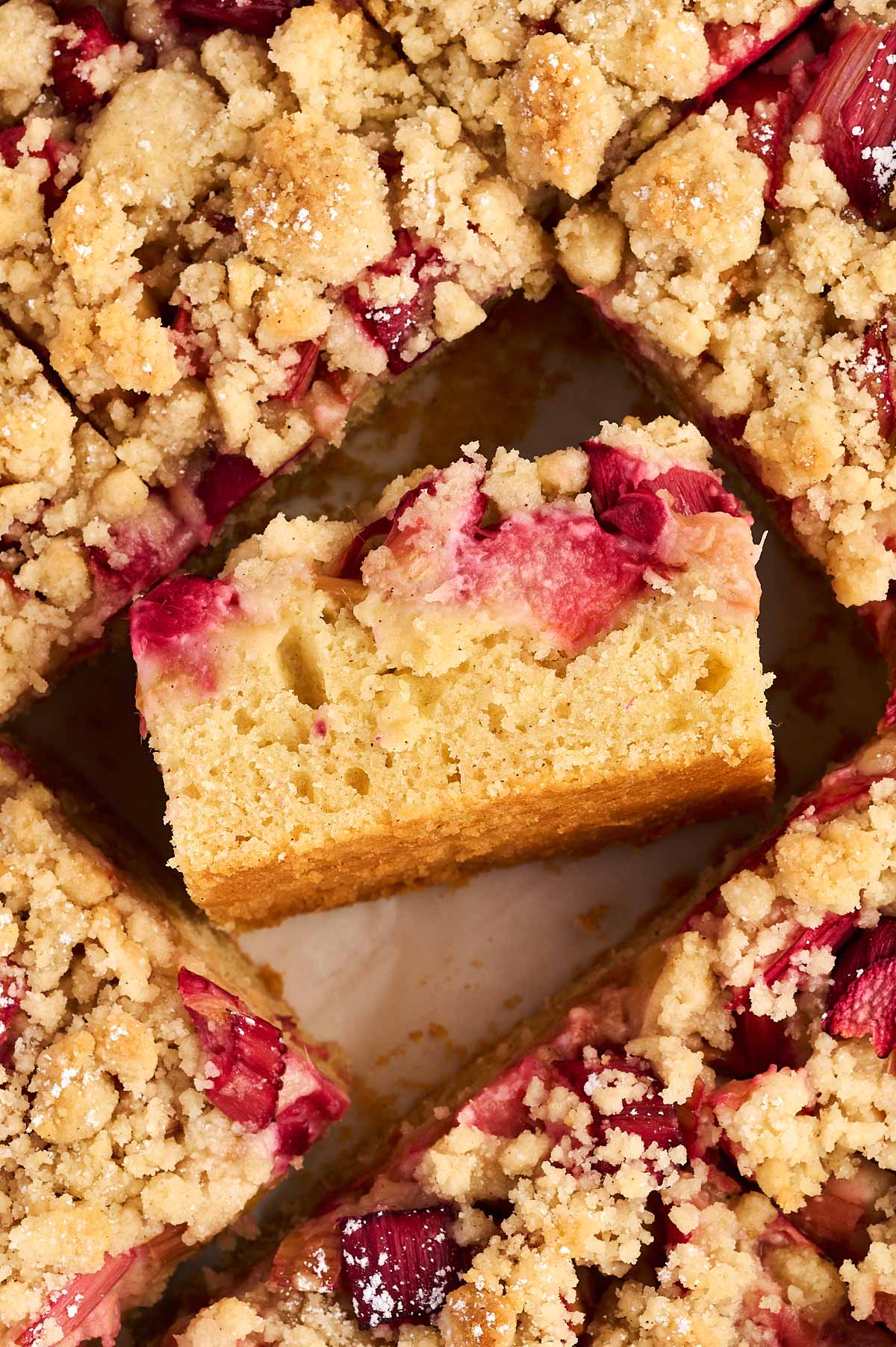 overhead view of sliced rhubarb coffee cake with a slice on the side