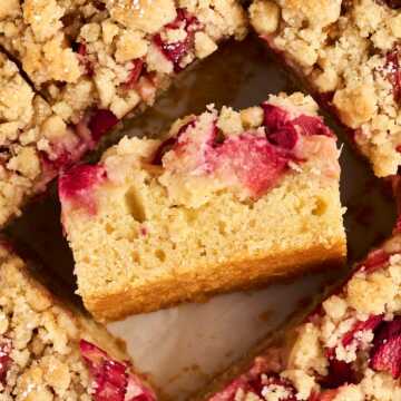 overhead view of sliced rhubarb coffee cake with a slice on the side