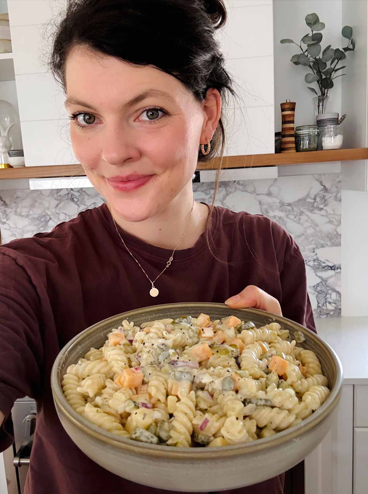showing a bowl of pasta salad to the camera
