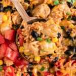 close up of spoon scooping Mexican chicken and rice