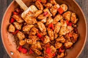 chicken, onion, peppers and seasoning in skillet