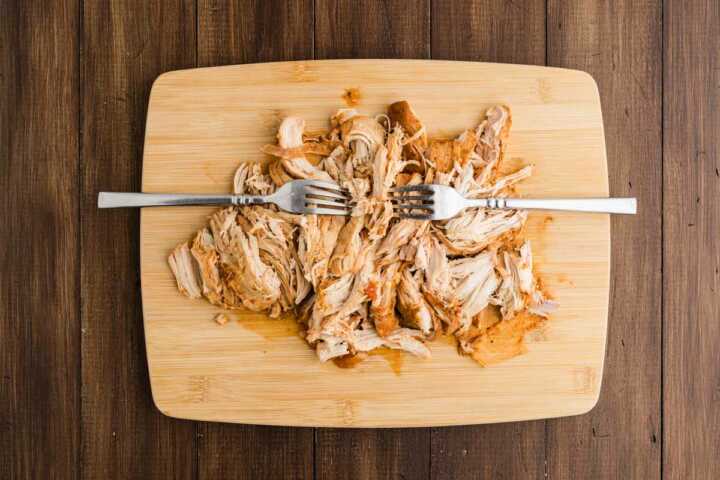 shredded chicken on wooden board