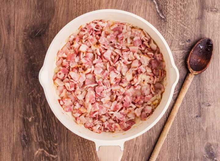 cooked bacon and onion in skillet