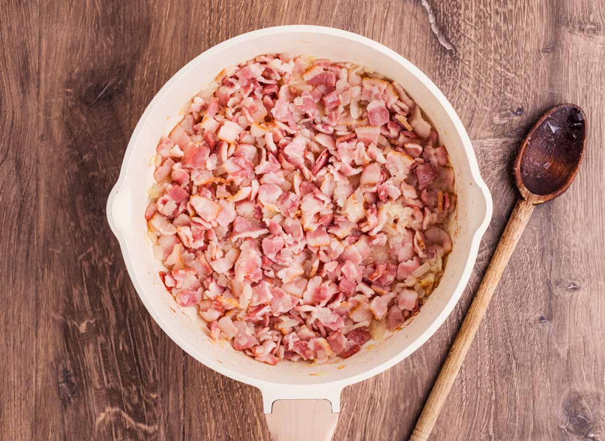 cooked bacon and onion in skillet