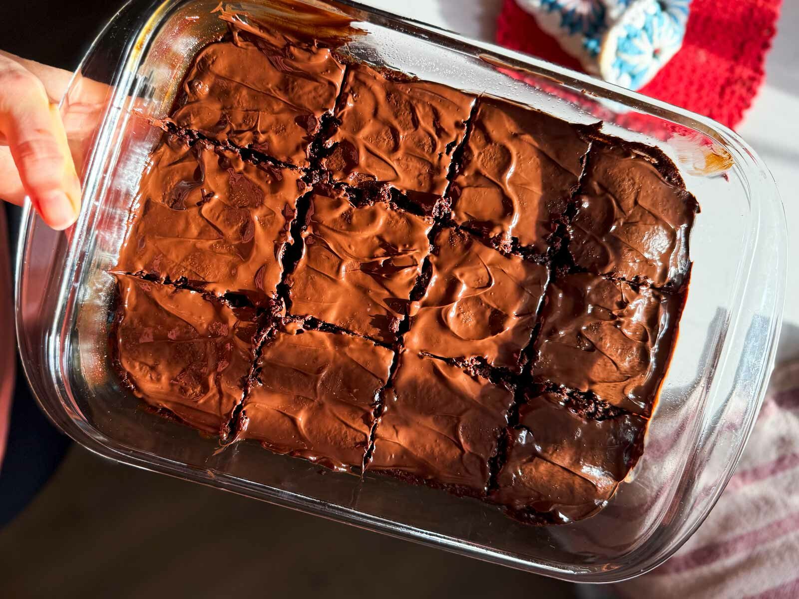 holding a pan full of brownies