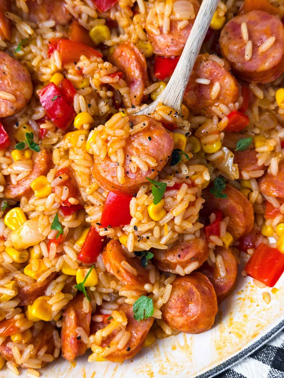 close up photo of spoon scooping up rice skillet