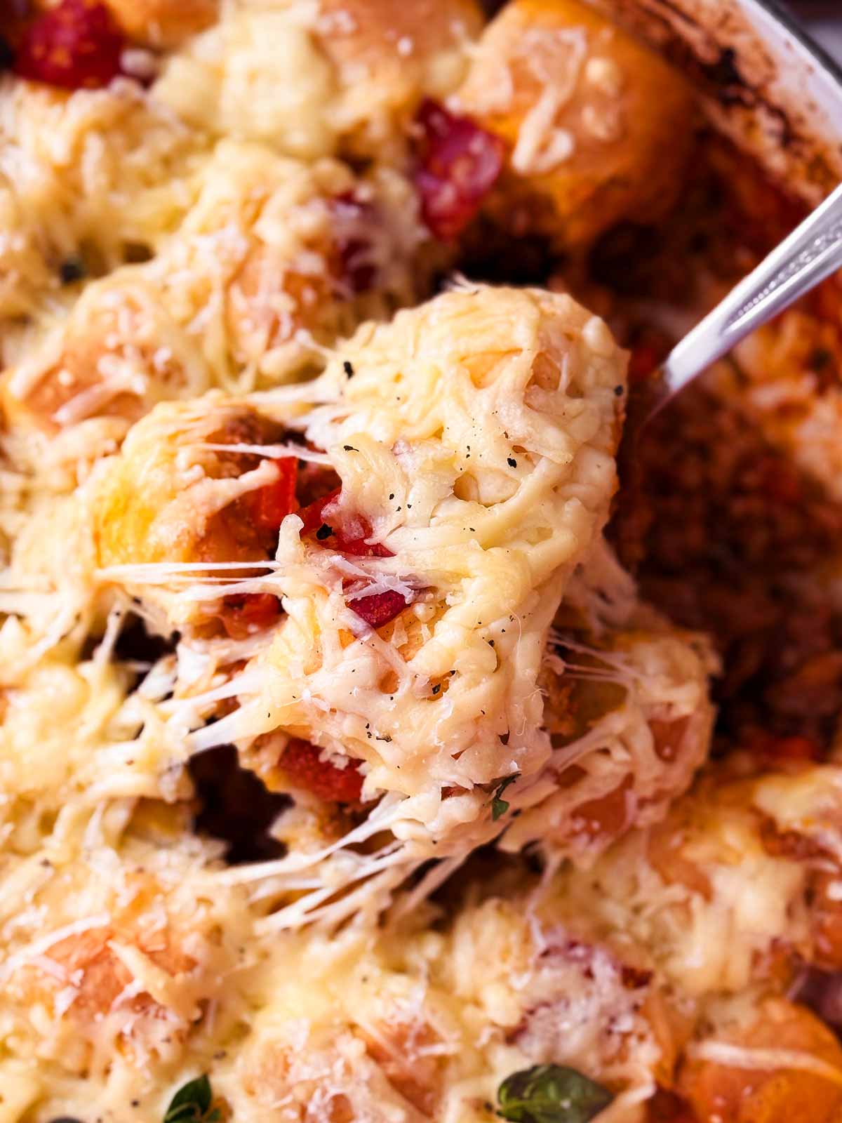 close up of cheese pull in pizza casserole