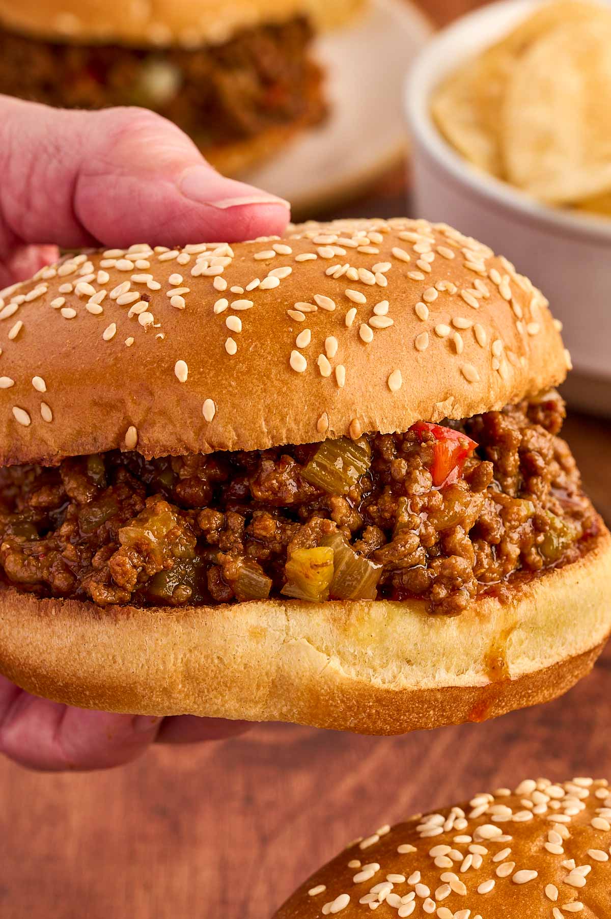 male hand holding a sloppy joe