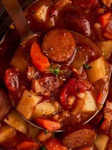 Scooping up bonfire stew.