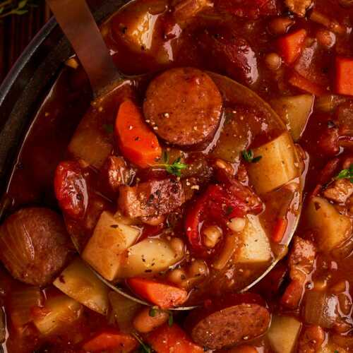 Scooping up bonfire stew.