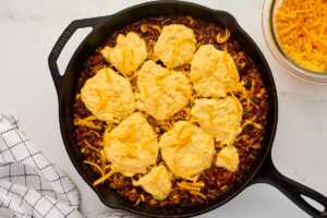 Preparing the chili cornbread casserole for baking.