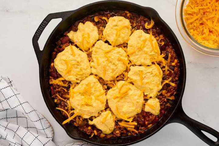 Preparing the chili cornbread casserole for baking.