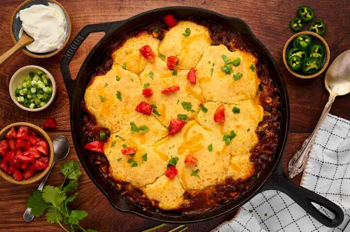 Serving a cozy dinner of chili cornbread casserole with toppings!