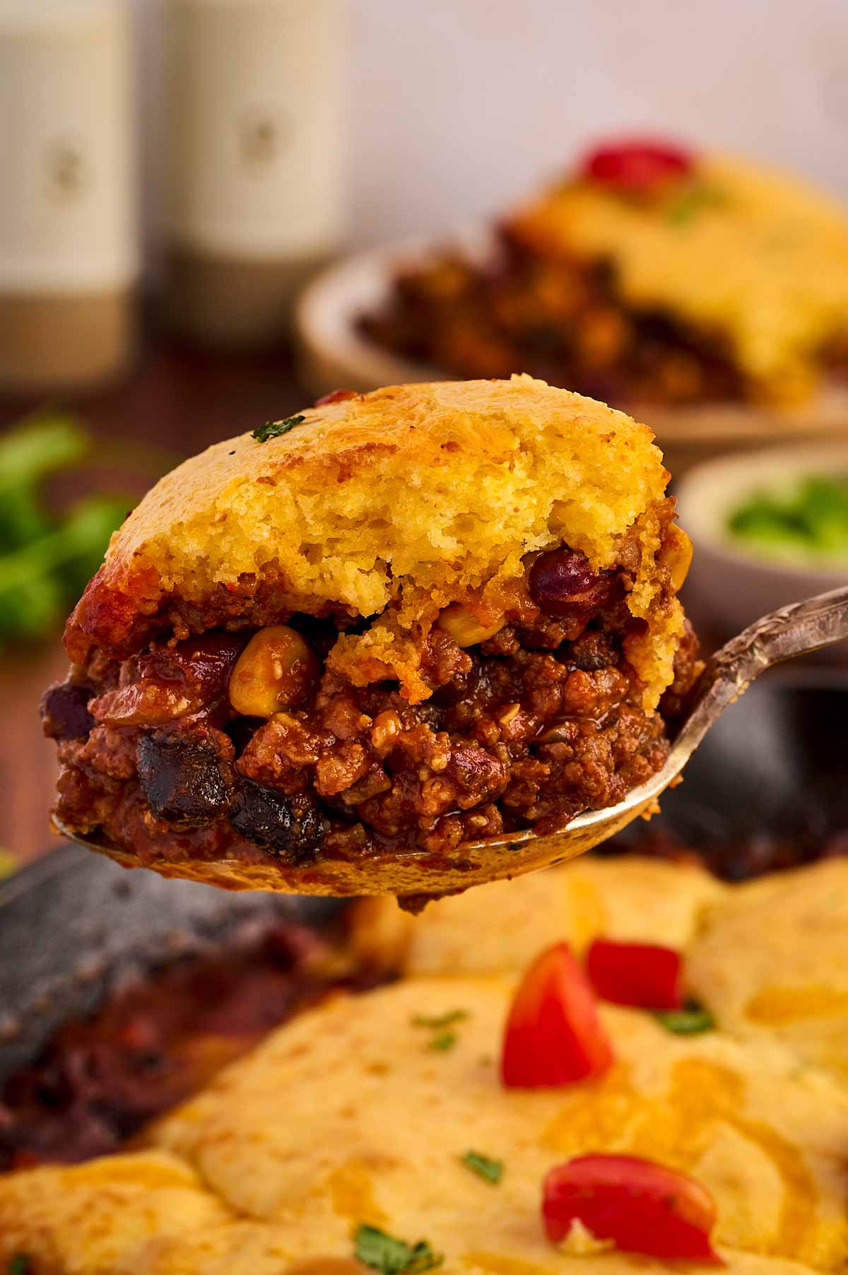 Scooping chili cornbread casserole.
