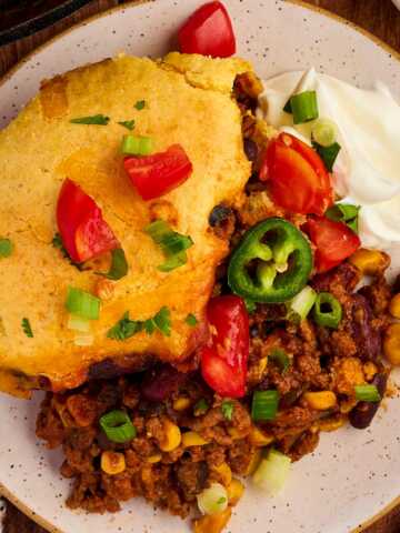 Yummy dinner of chili cornbread casserole with toppings.