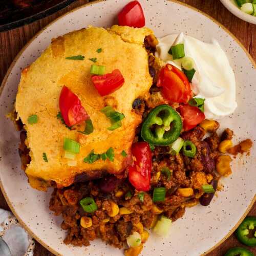 Yummy dinner of chili cornbread casserole with toppings.