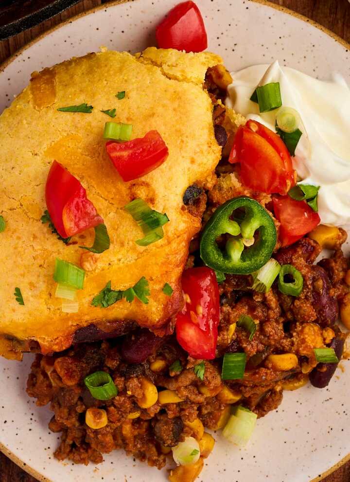 Yummy dinner of chili cornbread casserole with toppings.