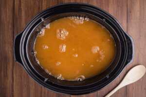 Preparing the apple cider for slow cooking.