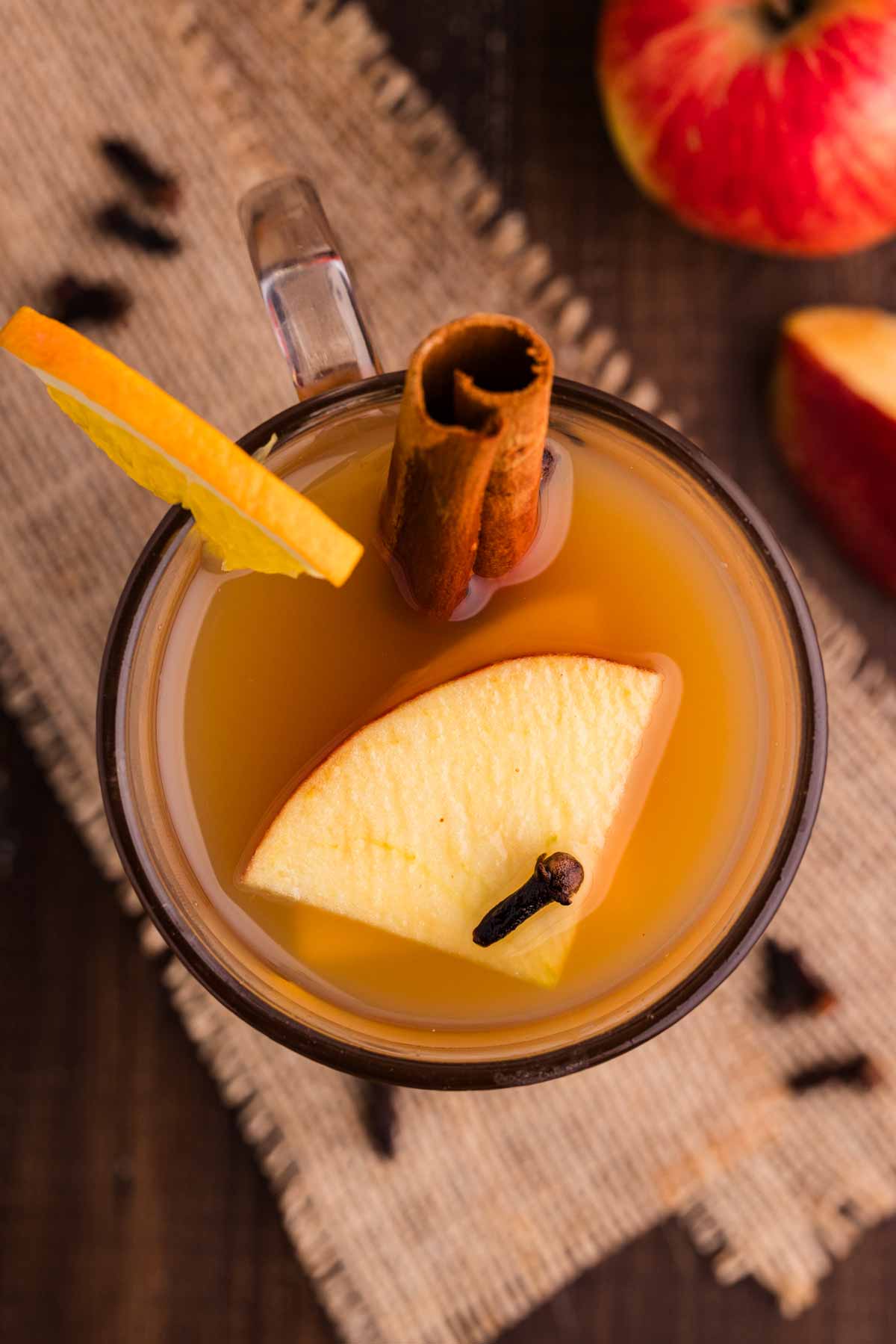 Hot spiced apple cider with cozy toppings.