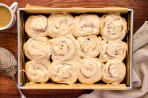 Serving apple butter cinnamon rolls with maple frosting.