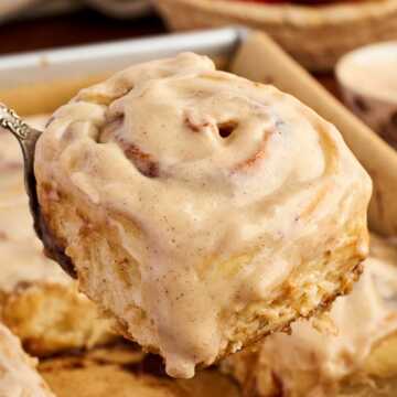 Serving a cinnamon roll with apple butter filling.