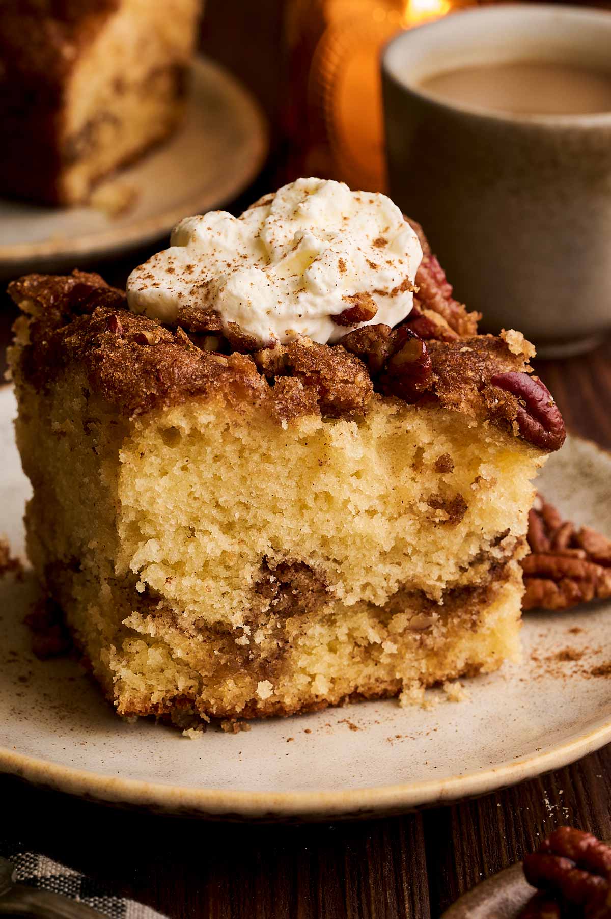 ready to eat slice of cinnamon pecan coffee cake with whipped cream