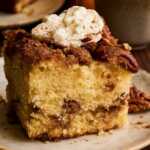 ready to eat slice of cinnamon pecan coffee cake with whipped cream