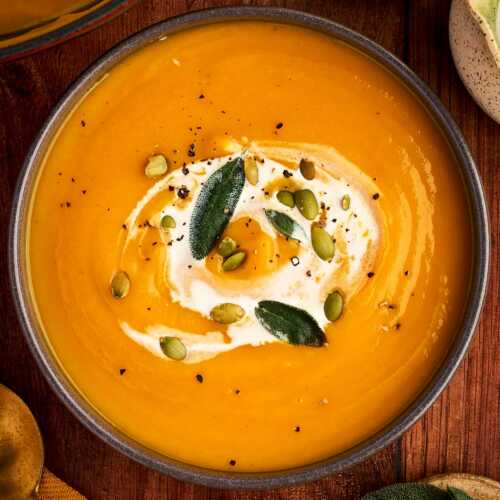 serving pumpkin soup in a cozy bowl