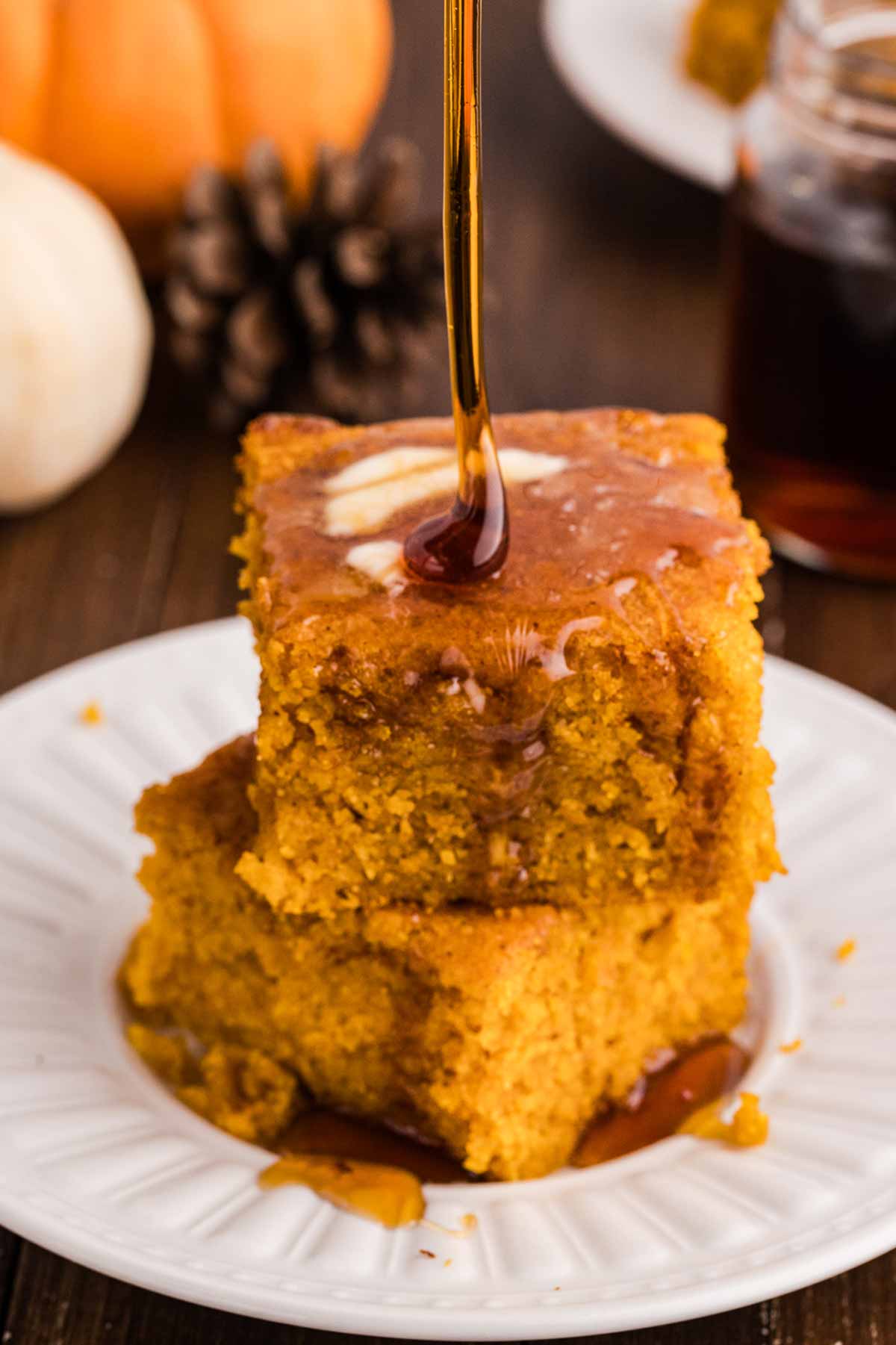 drizzling pumpkin cornbread with maple syrup