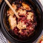 slow cooker beer cobbler with juicy berry filling and soft biscuit topping