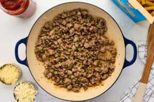 cooking vegetables and sausage in a skillet