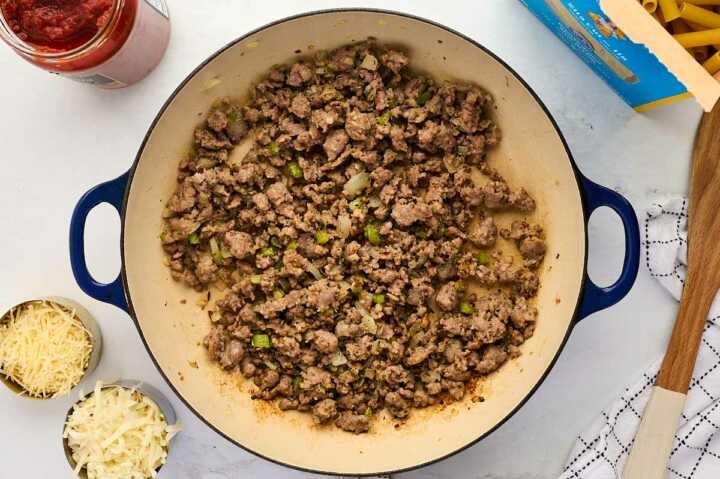 cooking vegetables and sausage in a skillet