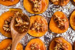 spooning pecan maple mixture over sweet potato slices