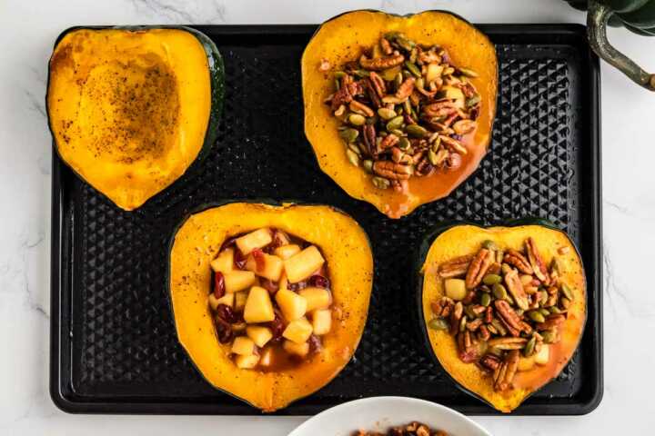 assembling stuffed acorn squash to bake