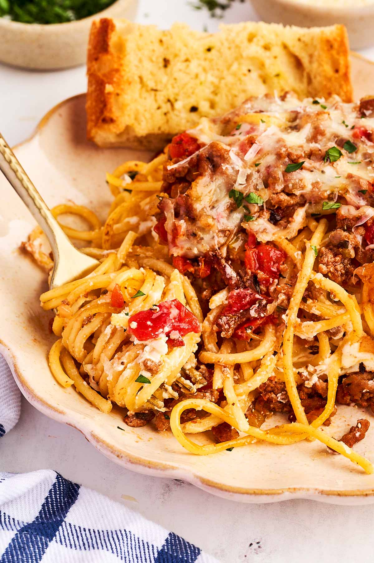 eating spaghetti casserole with garlic bread