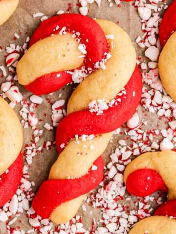 sprinkling candy cane cookies with chopped candy canes
