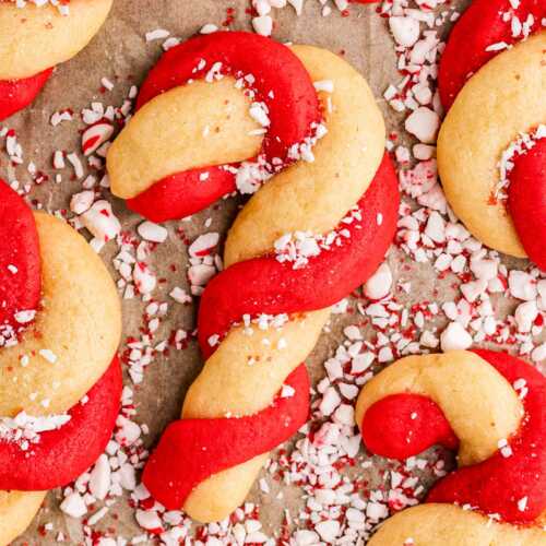 sprinkling candy cane cookies with chopped candy canes
