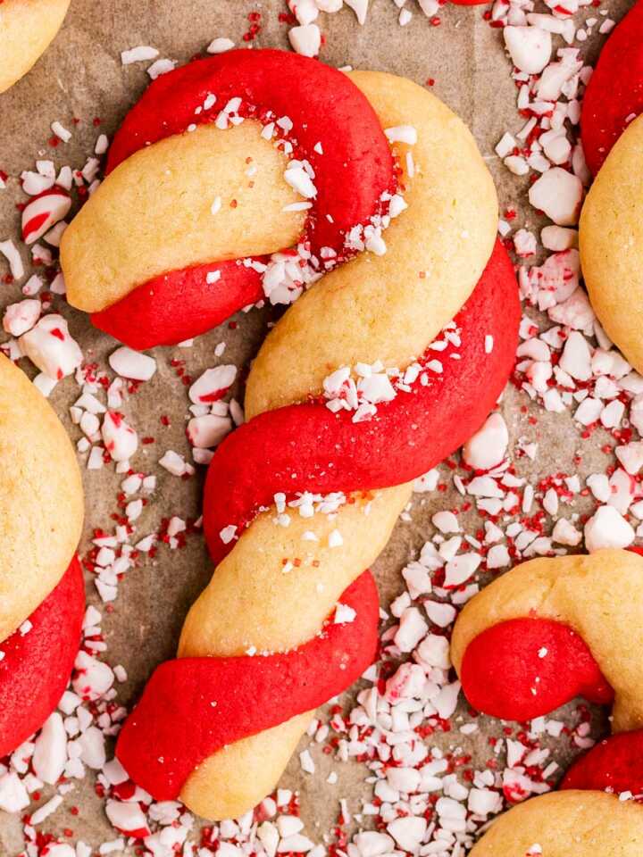 sprinkling candy cane cookies with chopped candy canes