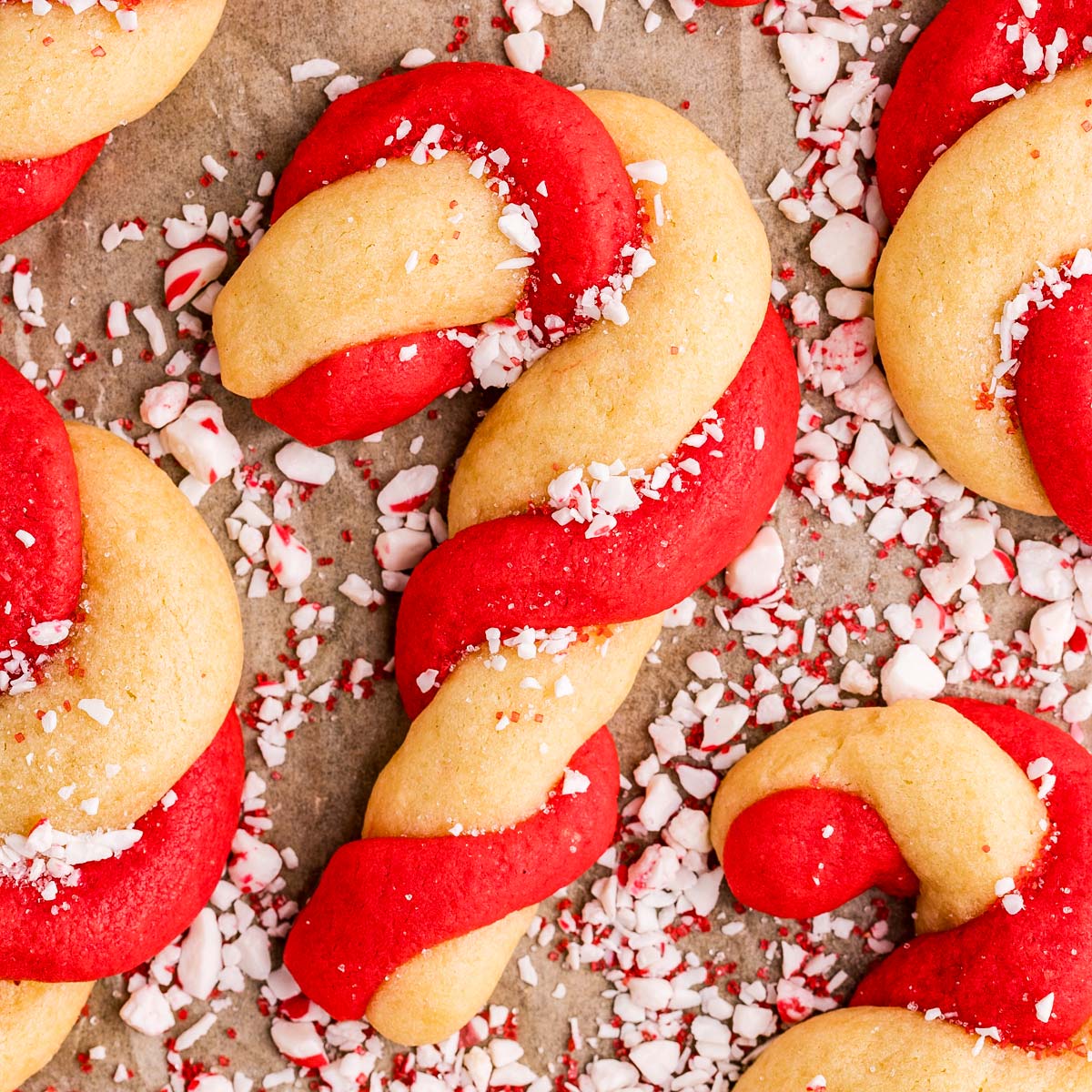 sprinkling candy cane cookies with chopped candy canes