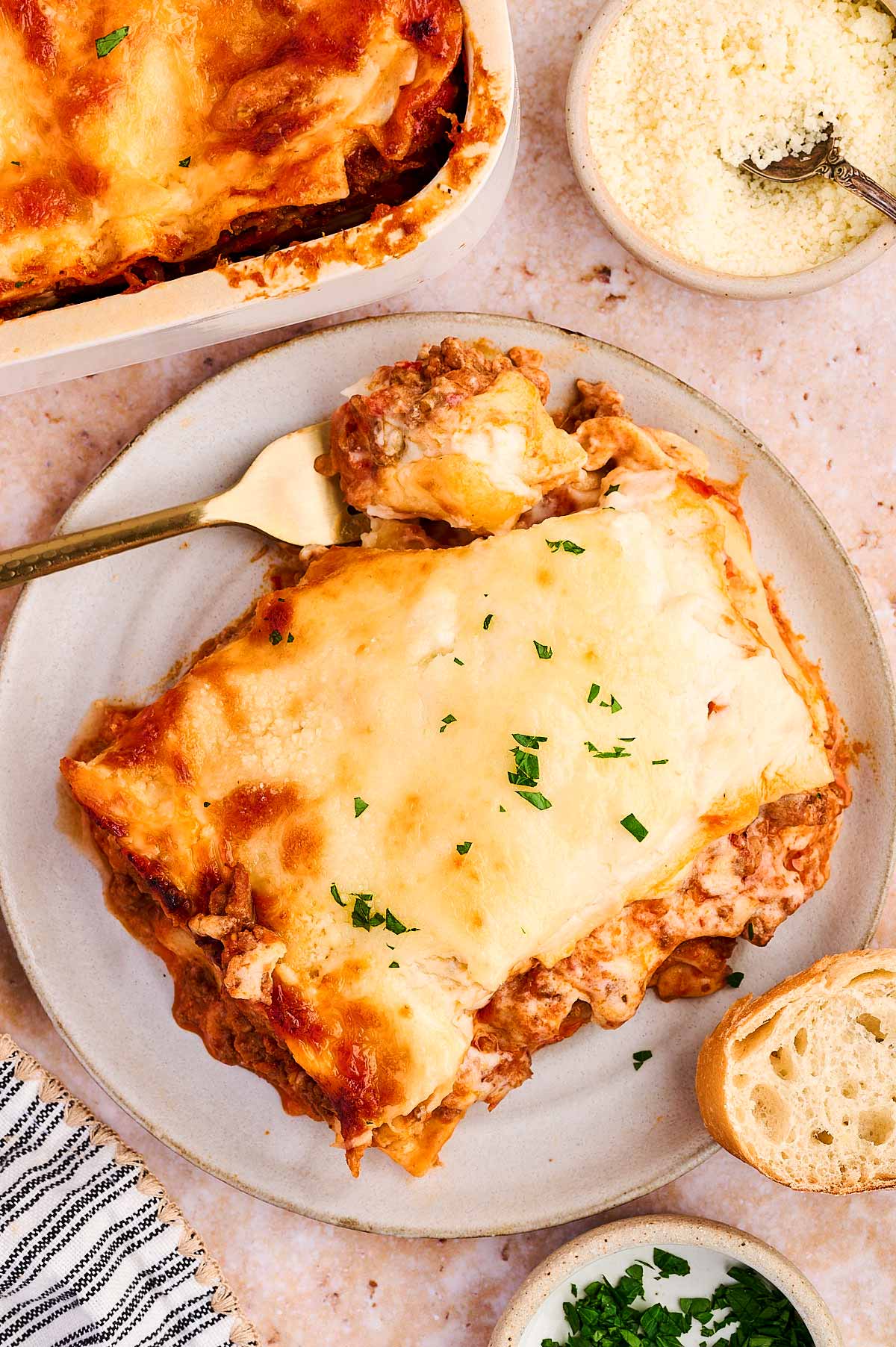 serving lasagna with garlic bread