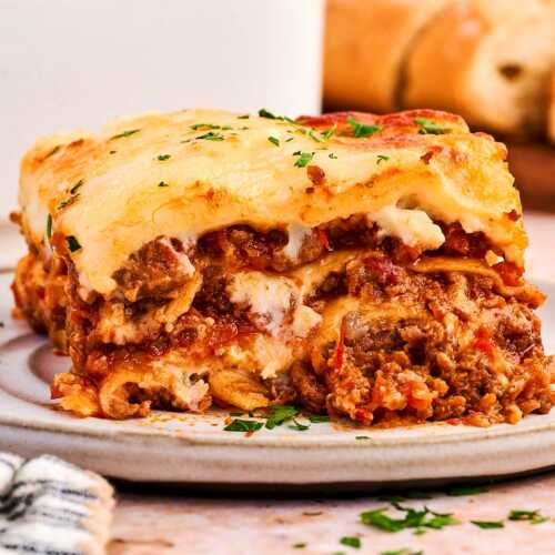 layers of cheesy lasagna on a plate