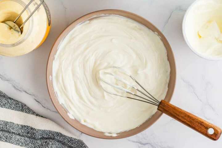 Whisking the base for dill dip.