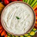 Serving dill dip in a bowl with plenty of vegetable sticks.