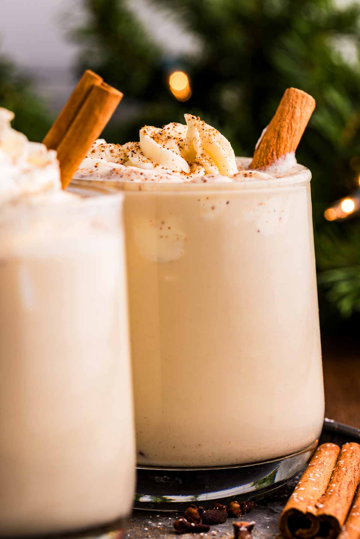 creamy eggnog in front of Christmas decorations