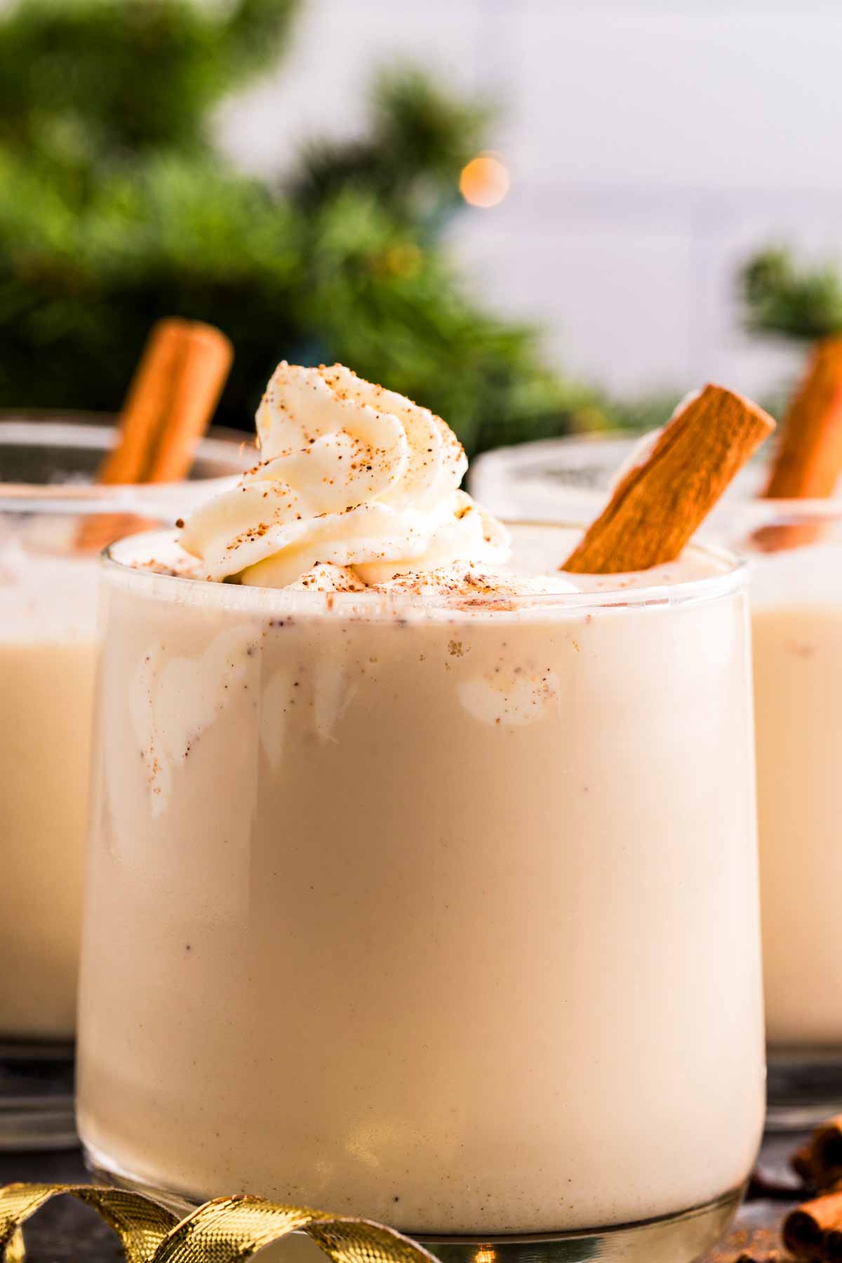 eggnog in a glass with whipped cream